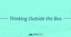 The text "Thinking Outside the Box' reads in navy blue text overtop a bright aqua blue background with a digital design effect watermarked underneath. The logo for Blue Canopy Marketing is placed at the bottom center of the image.