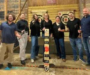 Blue Canopy Marketing team group photo during an axe throwing team-building event.